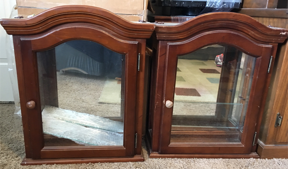 Photo 2 curio cabinets mirrored back glass shelf can hang on wall or set on desk top. $10 each 24”x20”x7” one has bad spot on top left corner.